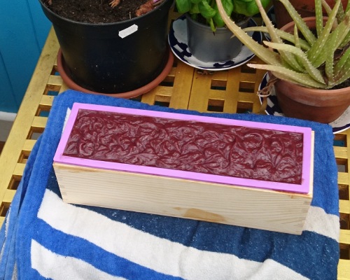 Handmade soap in mould on towel.