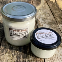 3 clear glass jars, one large, one small, containing body butter.